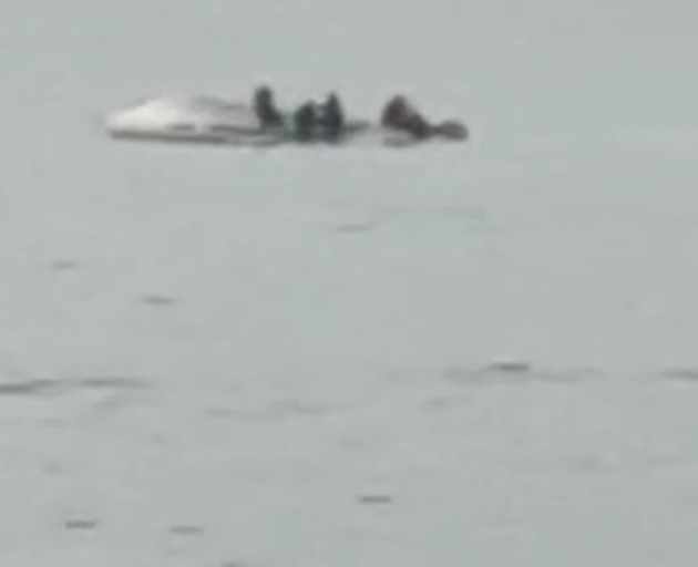 People could be seen clinging to the hull of an overturned boat following an incident off Goose...