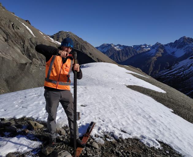 University of Otago Department of Zoology researcher Nick Foster installs a motion-activated...