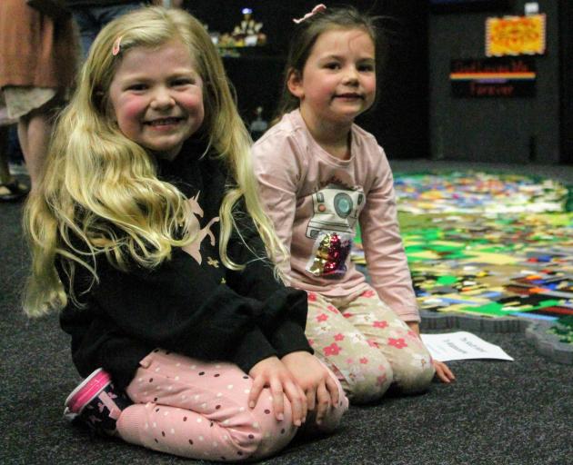 Invercargill girls Penny Sloan (6, left) and Heidi Lawson (5) have fun with Matthew Bennett's...