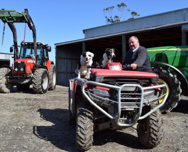 Ross Smaill, with working dogs Blondie (left) and Mate, is offering machinery at a clearing sale,...
