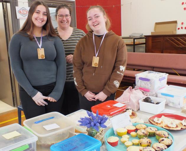 Volunteers (from left) Emily Braid, Tamsin Greer and Chloe Smith took a turn on the cake stall....