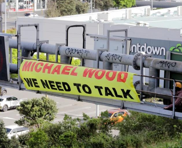Two Restore Passenger Rail campaigners on top of the State Highway 1 gantry . Photo: RNZ