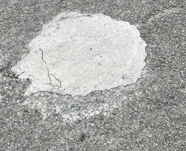 A DIY pothole cement fill on a road in Palmerston North. Photo: Palmerston North City Council