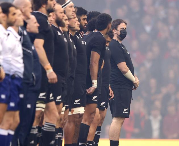 A pitch invader stands next to the All Blacks during the Autumn International match between Wales...