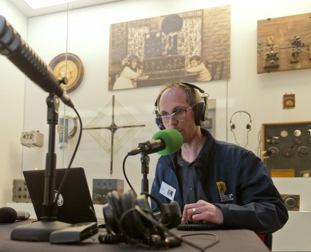 Against a backdrop of vintage broadcasting paraphernalia, Radio Dunedin volunteer announcer Steve...