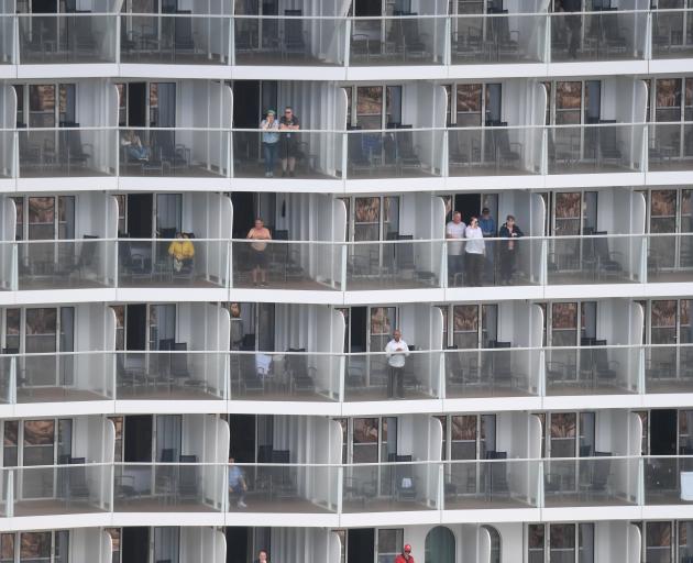 Passengers on Ovation of the Seas watch as the ship comes into Port Chalmers yesterday. Photos:...