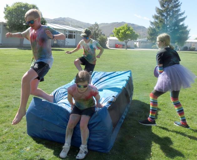 Lochy Hawkins (11) is chased by his brother Stanley (8) as Ashlynn McInnes (8) takes an easier...