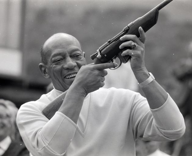 Berlin Olympic gold medallist Jesse Owens fires the ceremonial starter’s gun before the Charles...