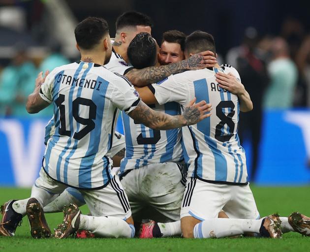 Argentina players swamp their captain Lionel Messi after claiming the World Cup. Photo: Reuters 