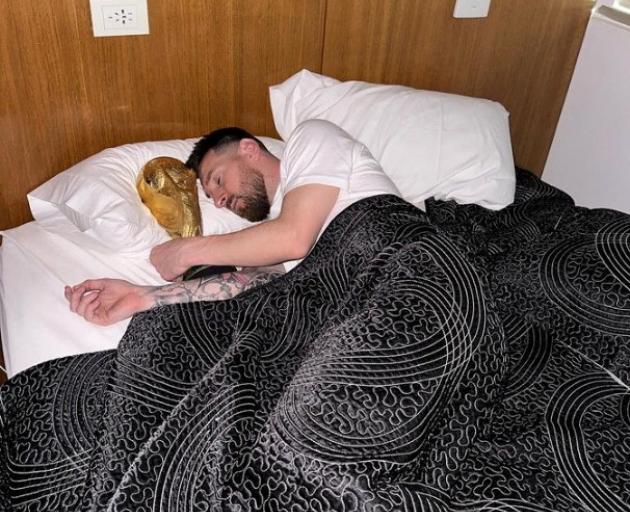 Lionel Messi posted this photo on Instagram of him waking up with the World Cup. Image: supplied...