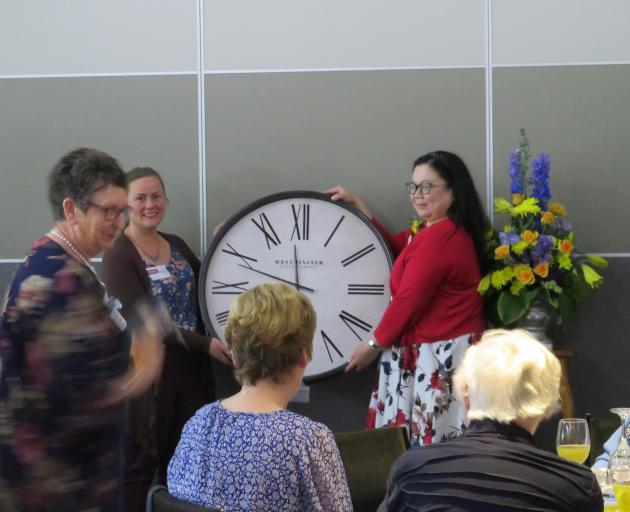 Mid Canterbury Hospice’s Fiona Giles accepts the wall clock from Mid Canterbury RWNZ provincial...