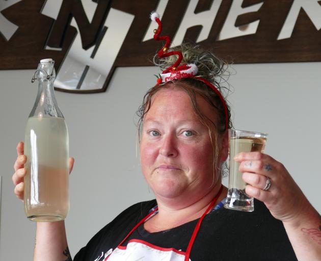 Kink n the Road Bistro & Bar cook Trudy Johnston holds samples of the discoloured tap water that...