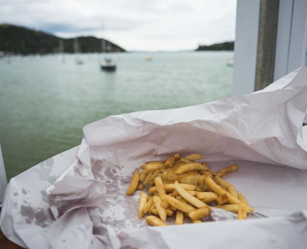Tourists love our fish and chips, but say we are missing curry sauce and mushy peas. Photo: Getty...