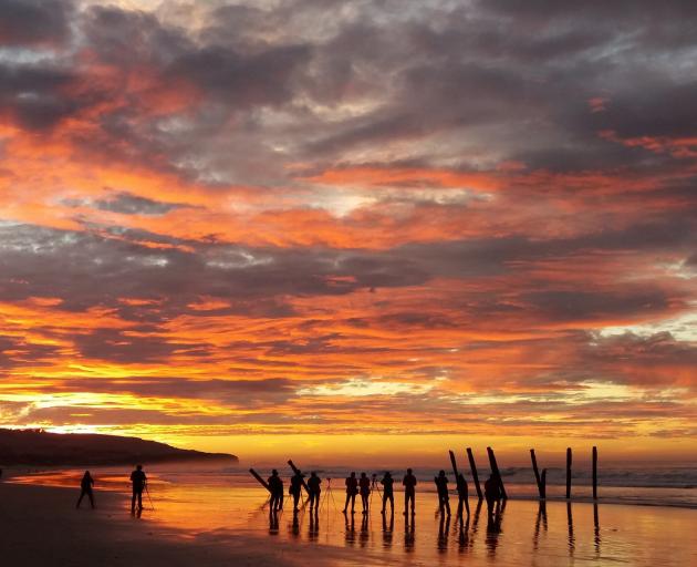 People gather around the poles in 2017. Photo: Darcelle Smith