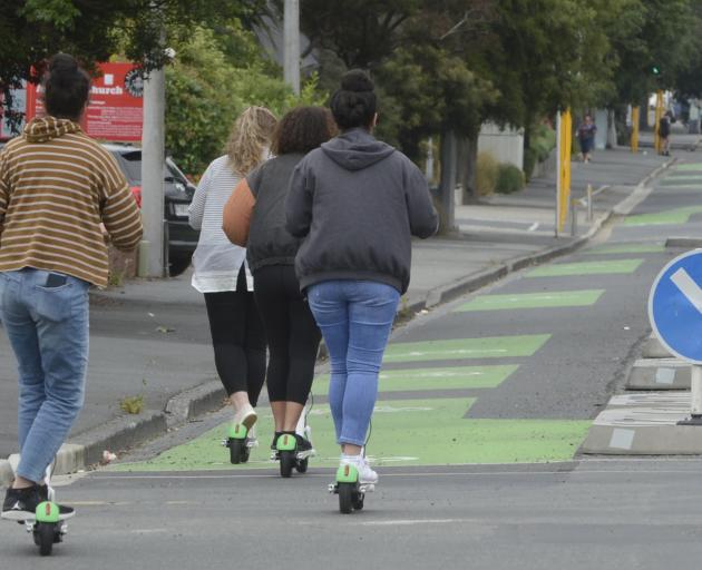 A small group of Lime scooter riders make their way down the Cumberland St cycleway. Photo: Gerard O'Brien