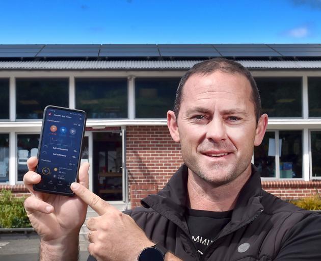 Sawyers Bay principal Gareth Swete shows off the app tracking how much power the school's solar...