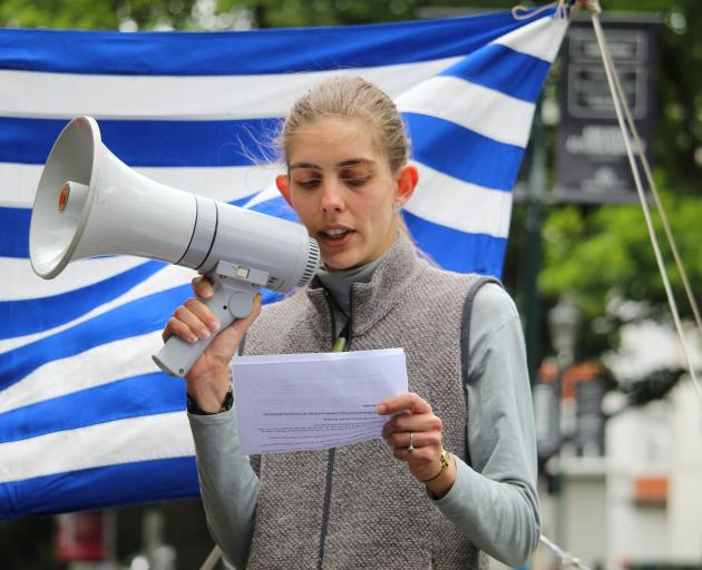 West Papua Support Dunedin member Ashley McMillan reads a message by an anonymous West Papuan...