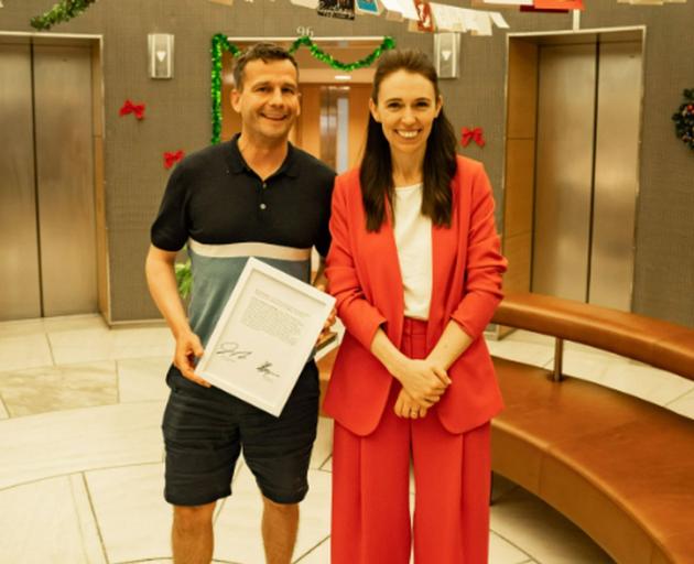 Act leader David Seymour and Prime Minister Jacinda Ardern with the framed copy of the Hansard...