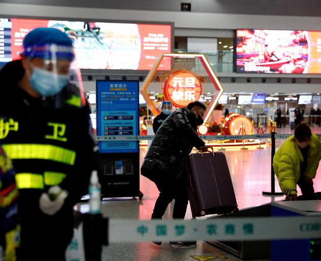 A traveller at a checkpoint at China's Chengdu Shuangliu International Airport at the weekend. A...