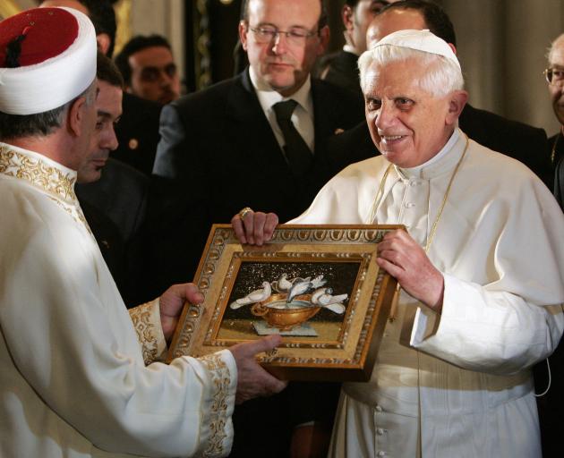 Pope Benedict XVI offers a gift to Istanbul's Grand Mufti Mustafa Cagrici during his visit to the...