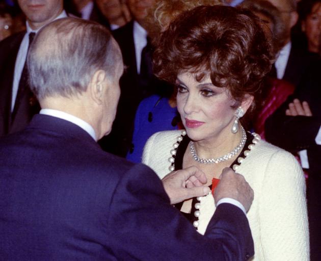 French President Francois Mitterrand presents Gina Lollobrigida with the "Legion d'Honneur" in...