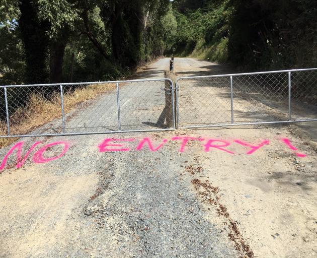 Gates and spray-painted messages are deterring cyclists on a partially completed section of the...