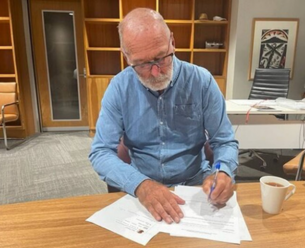Mayor Wayne Brown signs the declaration for a state of emergency in Auckland. Photo / Supplied