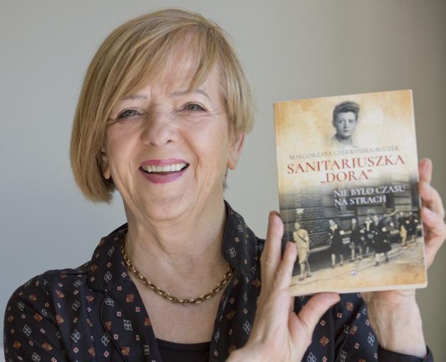 Dunedin woman Ewa Rozecka-Pollard holds up a book about her mother’s extraordinary life. PHOTO:...