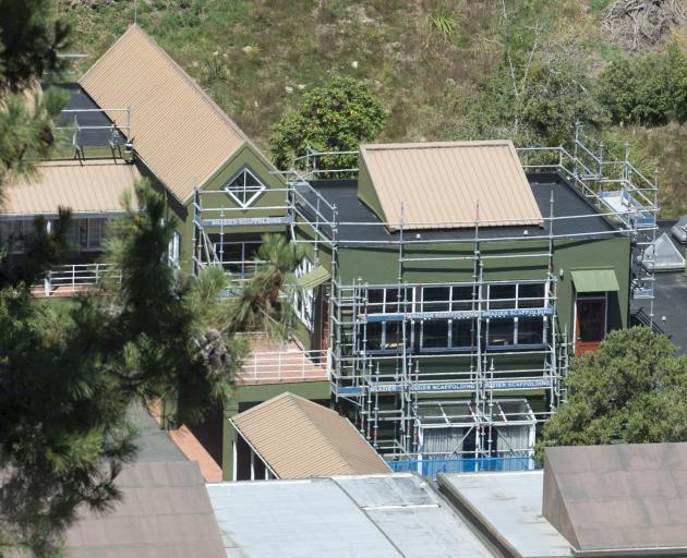 Scaffolding surrounds the mathematics block at Logan Park High School after mould was found at...