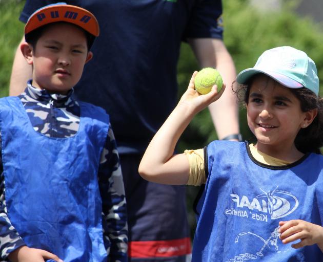 Enjoying a game of "netball-cricket" are Bao Nguyen (8) and Hannah Shoae (5). Photos: Simon...