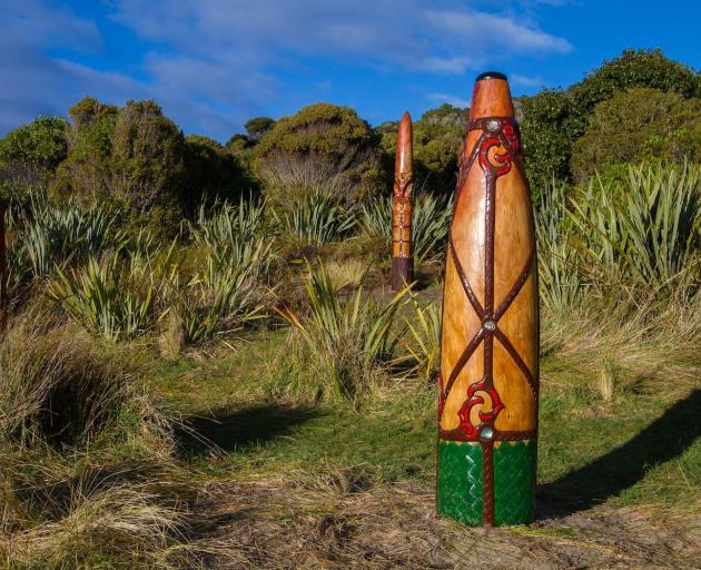 Three carved pou overlook the river mouth at Waikoropupu/Sealers Bay. PHOTO: TONY PRESTON