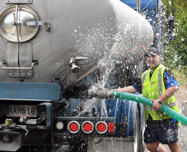 Dynes truck driver Tyler Anderton fills a tanker with water in Dunedin yesterday as a lack of...