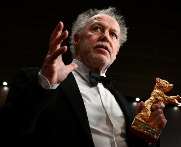Director Nicolas Philibert holds the Golden Bear for Best Film Award for On the Adamant during a...