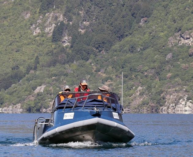 Plotting a course in Lake Wakatipu near Kingston to detect fish using an echo sounder transducer,...