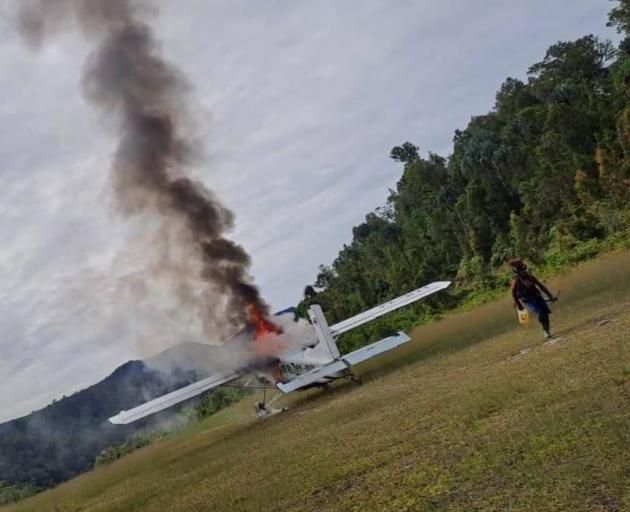 The Susi Air plane that Phillip Mehrtens was piloting being torched by the rebels Photo: Supplied...