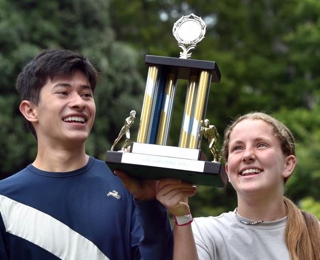 Josh Hou, of Dunedin. and Saffie Hare, of Gore, hold the Clock Tower Race winning trophy...