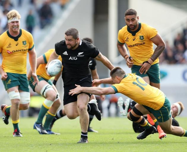 Dane Coles tries to evade the tackle of James O'Connor during the second Bledisloe Cup test....