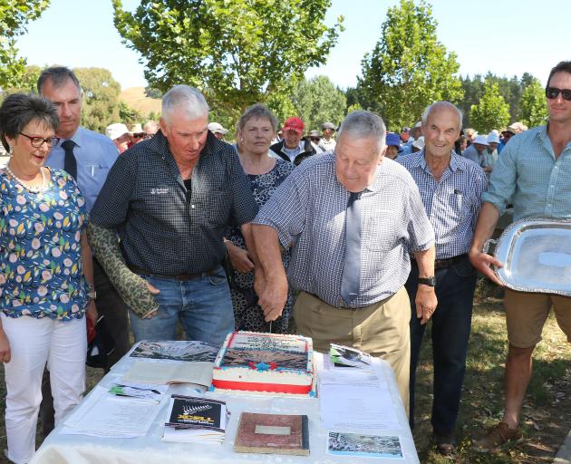 Laurie O’Carroll and Fred Fowler cut the 125th anniversary cake in Hawarden Saleyards recently....