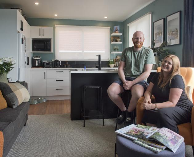 Interior designer Rachel Covey and her fiance Josh Nicholls relax in the living area of their...