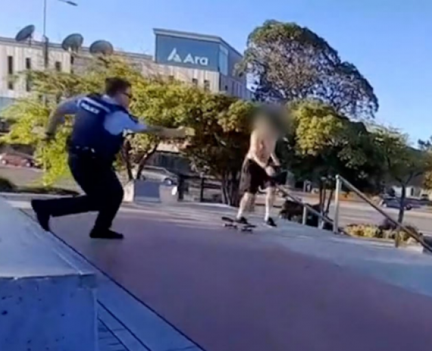 The officer approached with his Taser drawn.