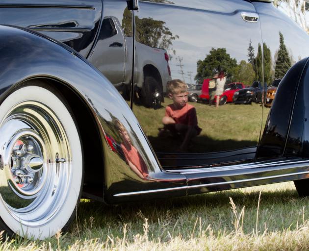 Jack Sutton (6), of Dunedin, inspects a 1939 Ford Deluxe Coupe at Rev ’n’ Ride yesterday. PHOTO:...