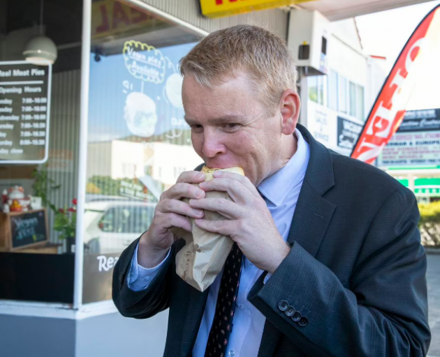 Prime Minister Chris Hipkins enjoys a pie from his favourite shop in the Hutt. Photo: NZ Herald 