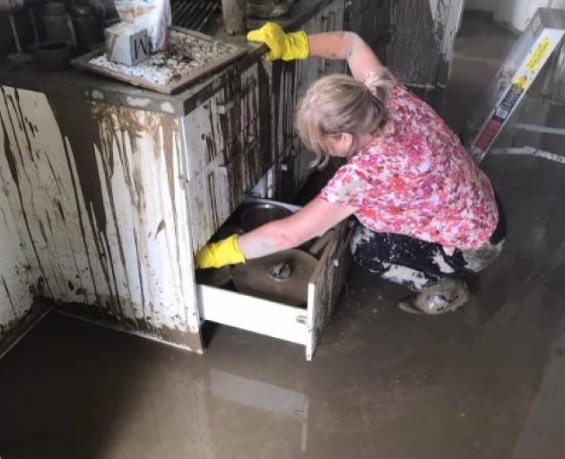 Dee Southall searching for salvageable items in her home in the days following Cyclone Gabrielle.