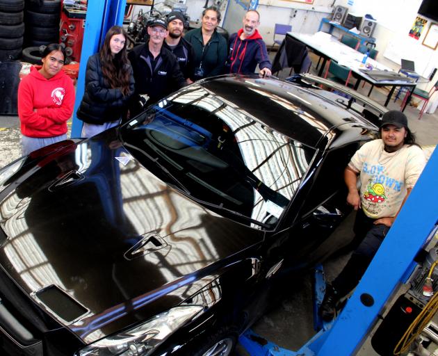 Getting ready to boost the speed of a 2008 Nissan R35 GTR sports car are (from left) students...