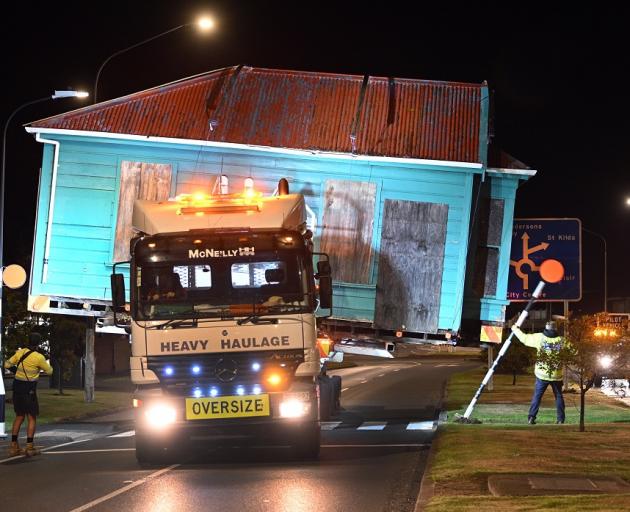 The historic Braemar Cottage makes its way down Andersons Bay Rd early yesterday morning. PHOTO:...