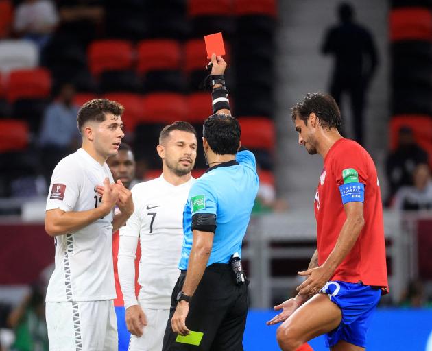 New Zealand's Kosta Barbarouses is shown a red card by referee Abdulla Hassan Mohammed. Photo:...