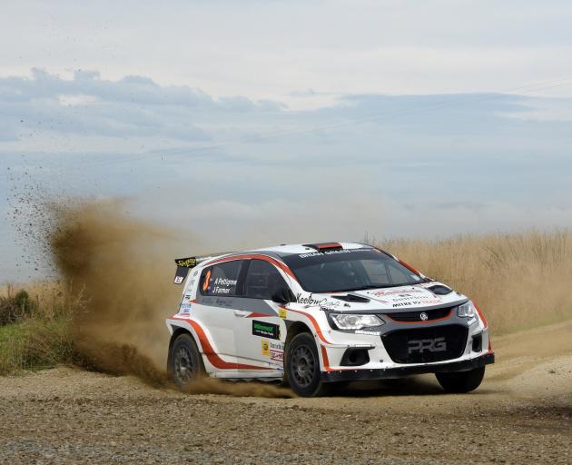 Sending gravel flying on the rally’s fourth stage near Oamaru, Ari 
...