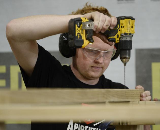 Third-year building apprentice Cameron Lynch focuses on building the frame of his children’s...