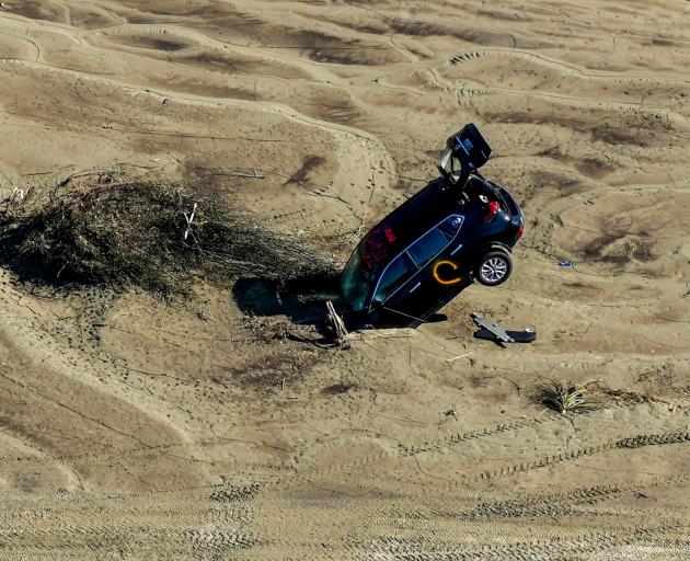 A car stuck in river silt in the aftermath of Cyclone Gabrielle in the Esk Valley near Napier....