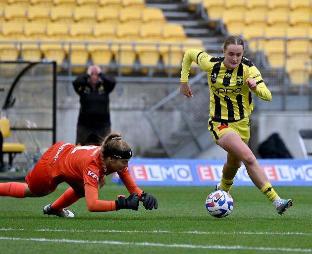 Ava Pritchard dribbles around Melbourne Victory goalkeeper Casey Dumont on her way to scoring the...